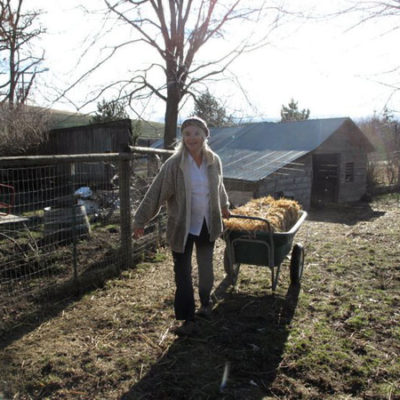 Photo of Joan Monteillet Pulling a Wagon with a Bale of Hay in January Sun