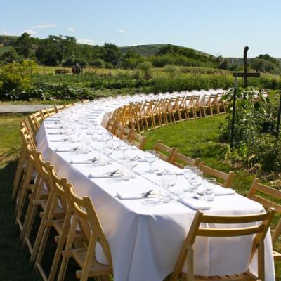 photo of long table set for dinner—2011 Outstanding in the Field Dinner—photo by The Farm Chicks