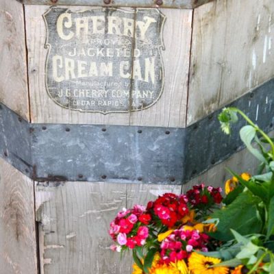 photo of antique cream can and flowers—2011 Outstanding in the Field Dinner—photo by The Farm Chicks