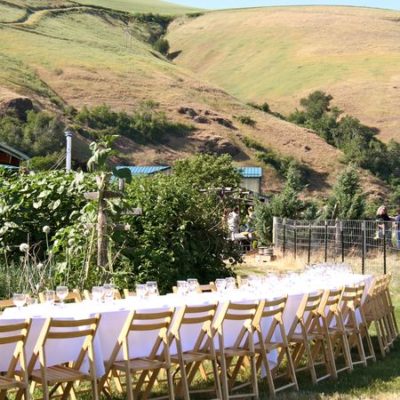 photo of set table in gardens—2011 Outstanding in the Field Dinner—photo by The Farm Chicks