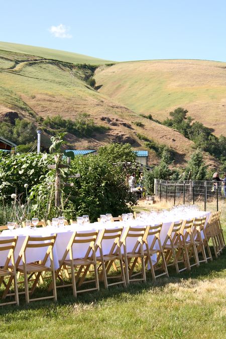 photo of set table in gardens—2011 Outstanding in the Field Dinner—photo by The Farm Chicks