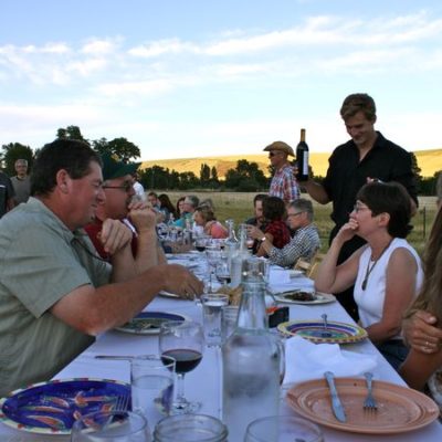photo of people enjoying their meal—2011 Outstanding in the Field Dinner—photo by The Farm Chicks