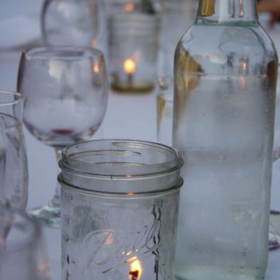 photo of lighted candle in a ball jar—2011 Outstanding in the Field Dinner—photo by The Farm Chicks
