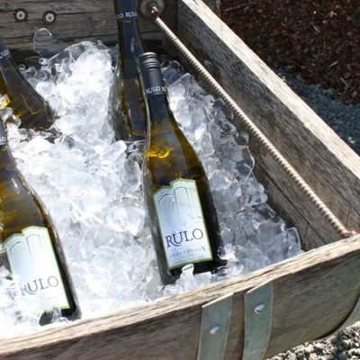 photo of bottles of wine chilling on ice—2011 Outstanding in the Field Dinner—photo by The Farm Chicks