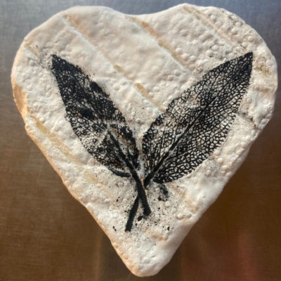 heart-shaped cheese with a leaf stencil